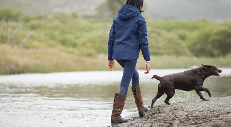 woman walking with dog in water